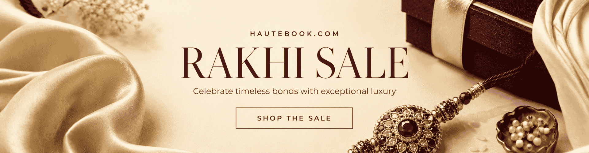Promotional banner for 'RAKHI SALE' featuring elegant cream and gold draped fabrics, a close-up of a detailed ornate pendant, a dark gift box, and a pearl bowl, with the text 'HAUTEBOOK.COM RAKHI SALE' and a 'SHOP THE SALE' button.