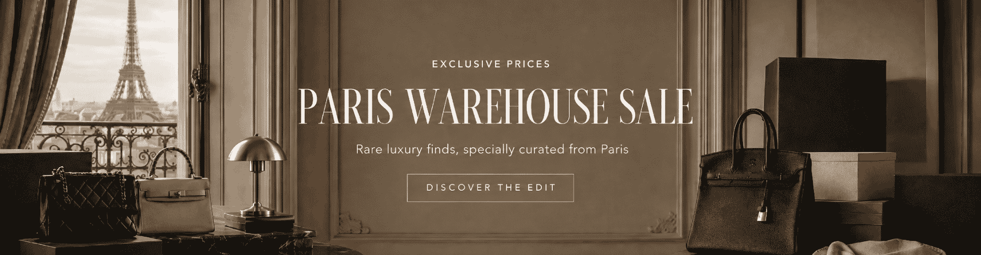 Promotional banner for 'Paris Warehouse Sale' featuring a sepia-toned interior scene with the Eiffel Tower visible through a window, alongside handbags, boxes, and furniture. Large text reads 'PARIS WAREHOUSE SALE' with smaller copy below and a 'DISCOVER THE EDIT' button.