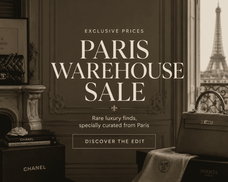 Promotional graphic for a Paris Warehouse Sale, featuring elegant sepia-toned interior decor, a window view of the Eiffel Tower, and luxury brands including Chanel and Hermès. Large centered text reads 'EXCLUSIVE PRICES PARIS WAREHOUSE SALE' with 'DISCOVER THE EDIT' below.